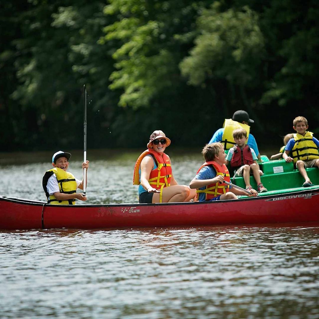 Family and friends riding down river in a canoe in Chesapeake, VA | Chesapeake Economic Development