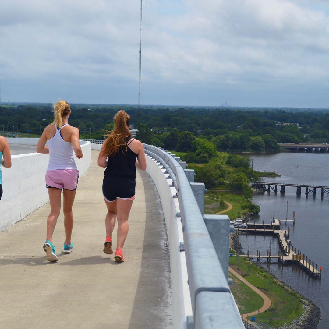 Women running on South Norfolk Jordan bridge in Chesapeake with overlook